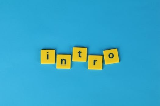 Yellow letter tiles spell 'intro' on a vibrant blue background, ideal for creative projects.